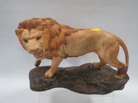 A BESWICK LION ON A ROCK