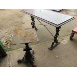 A CAST IRON TABLE AND A PEDESTAL TABLE BASE
