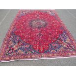 AN ORIENTAL RUG - 330 X 225 CM