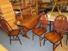 AN OAK DROPLEAF TABLE AND FIVE HOOP BACK CHAIRS