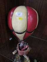 A MODEL OF A HOT AIR BALLOON AND PASSENGERS