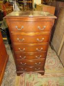 A REPRODUCTION MAHOGANY SERPENTINE SIX DRAWER CHEST