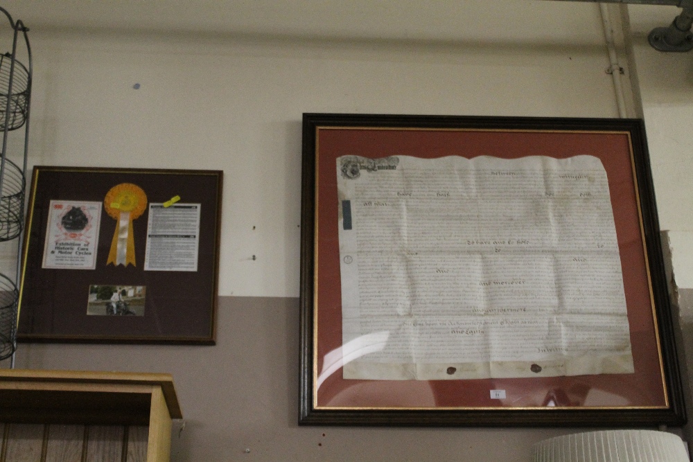 A LARGE FRAMED ANTIQUE INDENTURE TOGETHER WITH A FRAMED VINTAGE MOTORCYCLE DISPLAY (2)