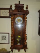 AN ANTIQUE VIENNA WALLCLOCK WITH ENAMELLED DIAL