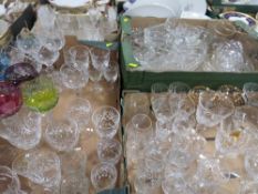 FOUR TRAYS OF ASSORTED GLASSWARE TO INCLUDE WINE GLASSES, COLOURED GLASS EXAMPLES ETC