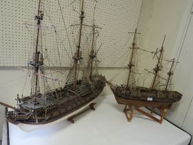 A VINTAGE SCRATCH BUILT MODEL OF A GALLEON TOGETHER WITH A LARGER EXAMPLE