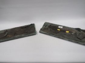 TWO CAST METAL PLAQUES OF MALE STUDIES IN CANOES