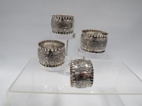 FOUR HALLMARKED SILVER NAPKIN RINGS