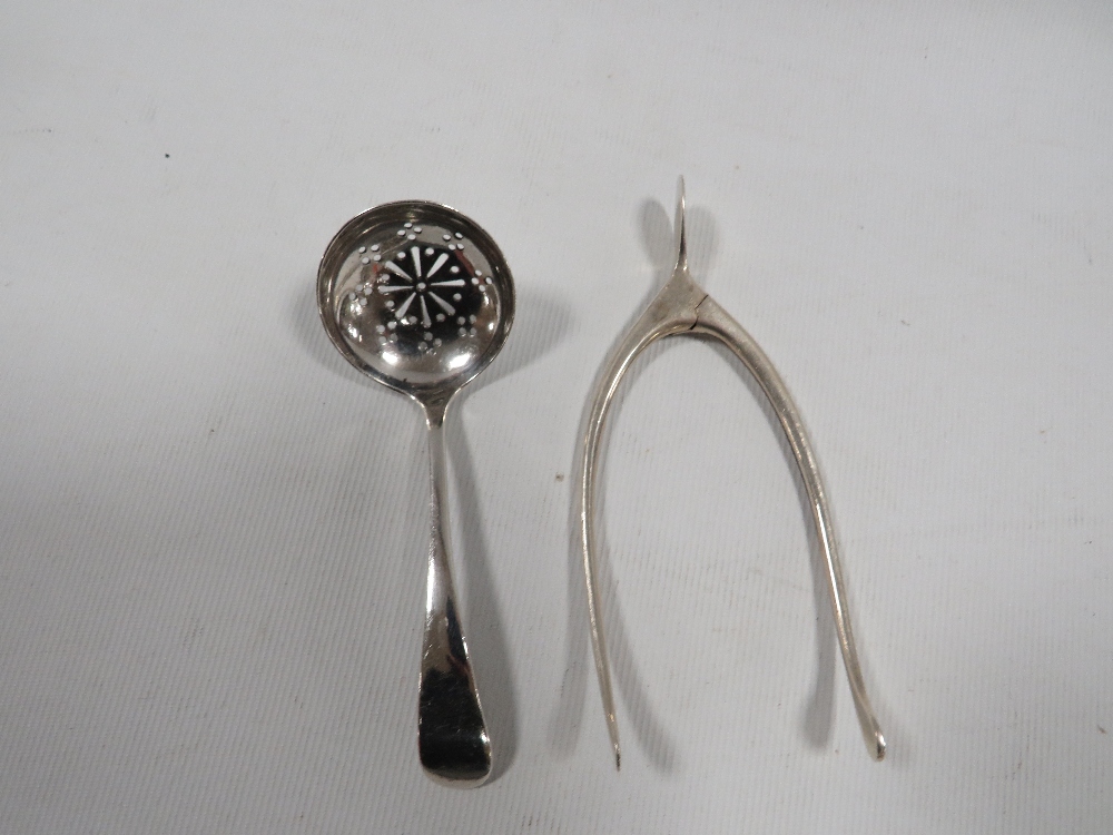 A PAIR OF HALLMARKED SILVER WISHBONE SUGAR TONGS TOGETHER WITH A HALLMARKED SILVER SIFTER SPOON (2)