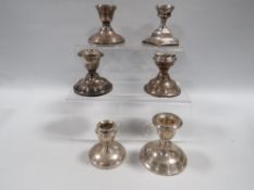 SIX ASSORTED HALLMARKED SILVER SQUAT CANDLESTICKS VARIOUS DATES AND MAKERS A/F