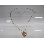 AN LOCKET ON CHAIN MARKED 9CT GOLD BACK AND FRONT