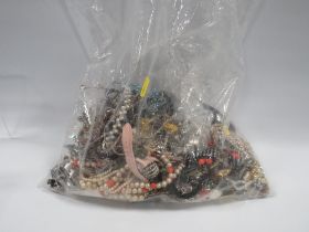 A LARGE BAG OF MIXED COSTUME JEWELLERY BRACELETS, WATCHES ETC