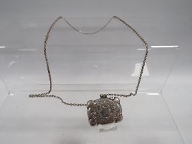 AN ANTIQUE SILVER VESTA CASE ON SILVER CHAIN