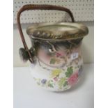 A VINTAGE CERAMIC DRAINING POT WITH WICKER WORK HANDLE