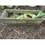 A HEAVY CONCRETE GARDEN PLANTER