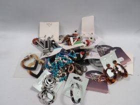 A BAG OF COSTUME JEWELLERY, NECKLACES, EARRINGS ETC