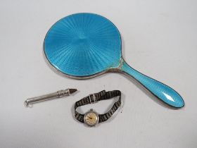 THREE ITEMS OF HALLMARKED SILVER, TO INCLUDE AN ENAMEL HAND MIRROR A/F , WATCH AND A SLIDE ACTION