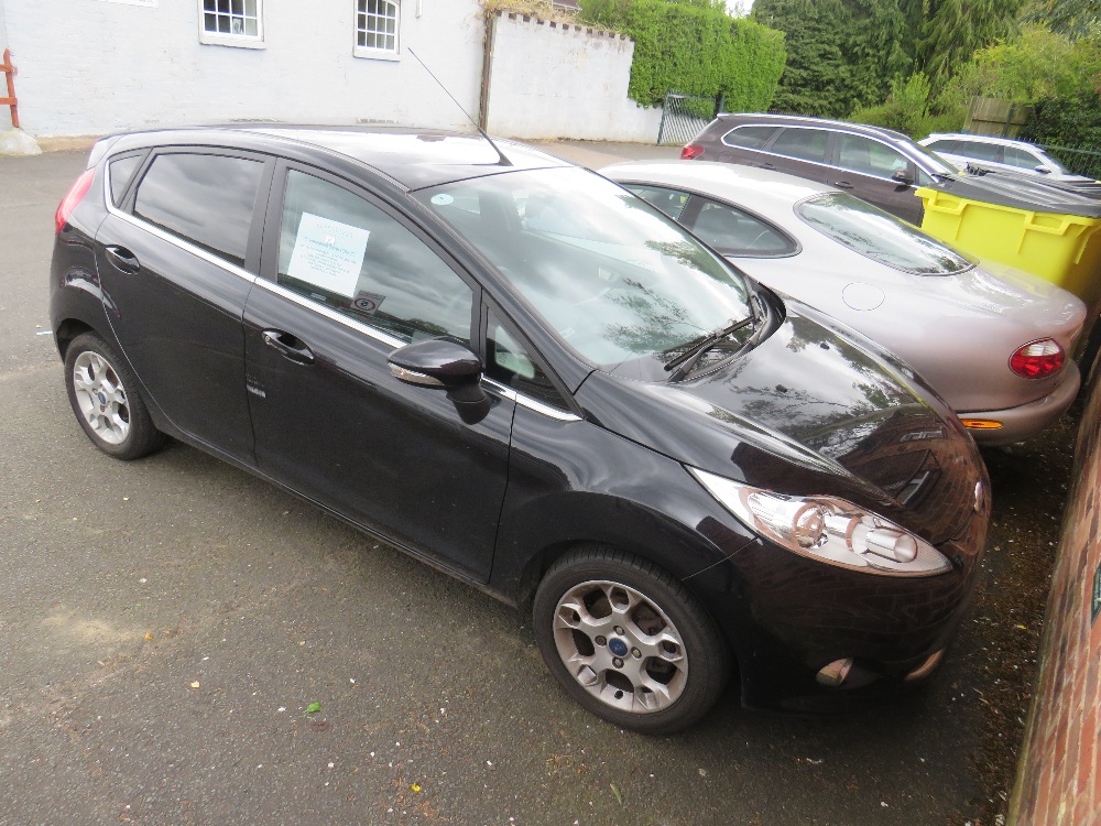 A BLACK 2011 1.4L PETROL FORD FIESTA 'BF61 HVR', LOG BOOK, TWO KEYS, CURRENTLY SORN, MILEAGE AT LAST