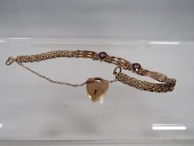 A VICTORIAN ROLLED GOLD BRACELET SET WITH AMETHYST COLOURED STONES