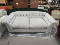 A MODERN UPHOLSTERED BUTTON-BACK SOFA