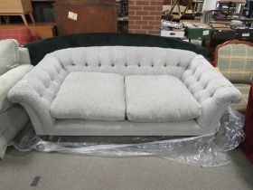 A MODERN UPHOLSTERED BUTTON-BACK SOFA