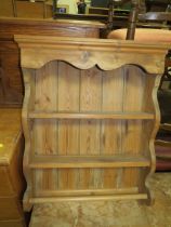 AN EDWARDIAN OVERMANTLE MIRROR AND PINE HANGING SHELF