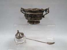 A HALLMARKED SILVER TOPPED GLASS MUSTARD POT ALONG WITH AN EASTERN WHITE METAL TWIN HANDLED BOWL AND