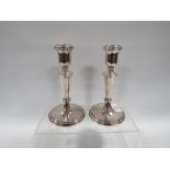 A GOOD PAIR OF WEIGHTED HALLMARKED SILVER CANDLESTICKS H 17 CM