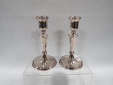 A GOOD PAIR OF WEIGHTED HALLMARKED SILVER CANDLESTICKS H 17 CM