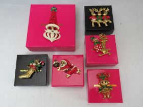 A COLLECTION OF BUTLER AND WILSON CHRISTMAS THEMED BROOCHES, comprising a large Santa brooch and