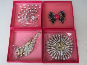 A SELECTION OF FOUR BUTLER AND WILSON COSTUME BROOCHES, to include a large articulated clear &