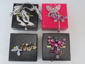 A BUTLER AND WILSON SHOE THEME BRACELET AND EARRING SET, together with three butterfly theme