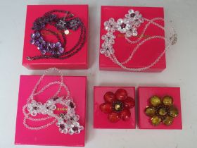 THREE FLORAL FACETED GLASS BEAD NECKLACES, together with two cabochon / bead flower brooches (5)