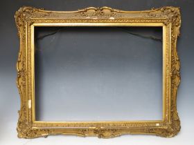 A 19TH CENTURY DECORATIVE GOLD SWEPT FRAME, with gold slip, frame W 8 cm, slip rebate 45 x 60, frame