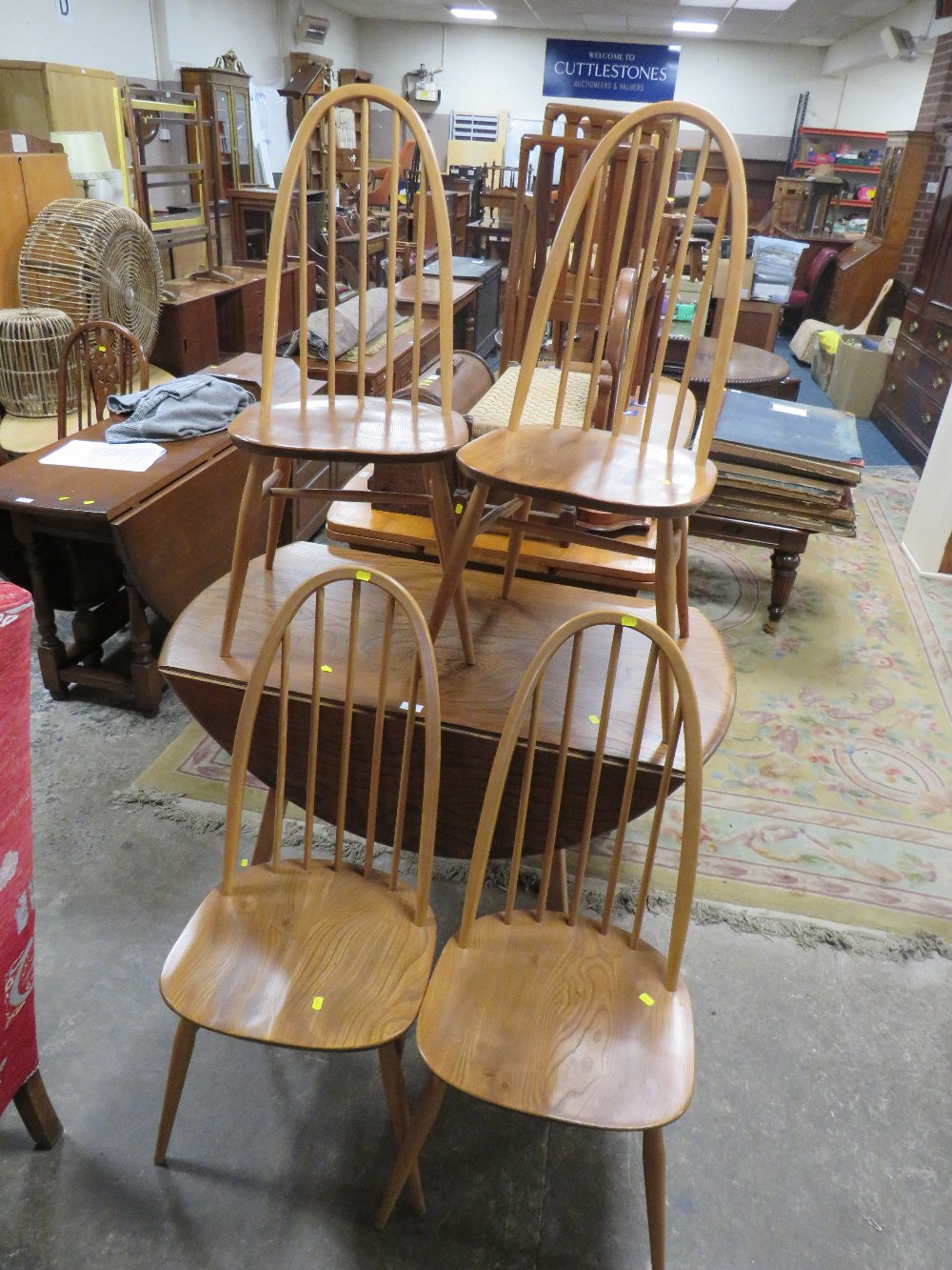 AN ERCOL STYLE DROPLEAF TABLE WITH FOUR HOOPBACK CHAIRS