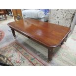 A MAHOGANY COFFEE TABLE WITH BRASS CASTORS