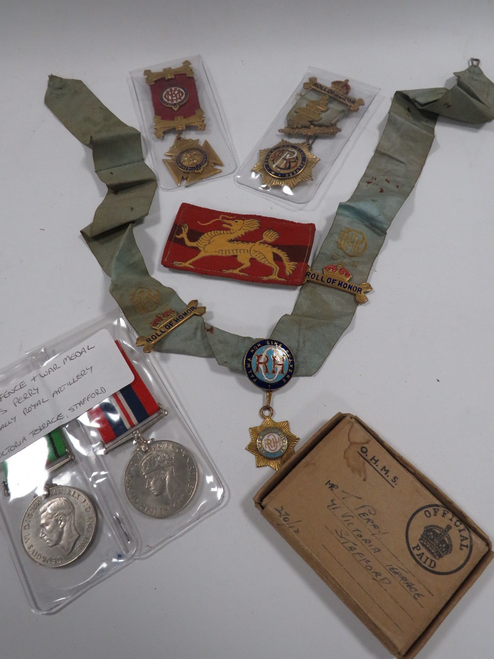A QUANTITY OF WAR MEDALS, BADGES ETC TO INCLUDE AN O. H.M.S BOX ADDRESSED TO MR T. PERRY OF 71