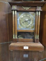 A VINTAGE MANTEL CLOCK WITH PENDULUM