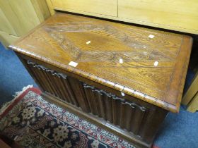 A CARVED OAK PANELLED COFFER