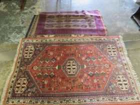 TWO EASTERN WOOLLEN RUGS - RED / BLACK GROUND 128 X 76 CM AND 170 X 110 CM (2)