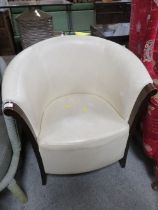 AN UPHOLSTERED TUB CHAIR