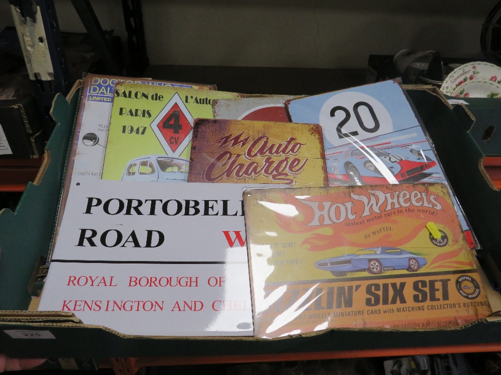 A BOX OF METAL ADVERTISING SIGNS