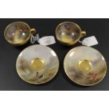 A PAIR OF ROYAL WORCESTER 'PHEASANT' CABINET CUPS AND SAUCERS - SIGNED J.A. STINTON C1921
