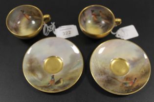 A PAIR OF ROYAL WORCESTER 'PHEASANT' CABINET CUPS AND SAUCERS - SIGNED J.A. STINTON C1921