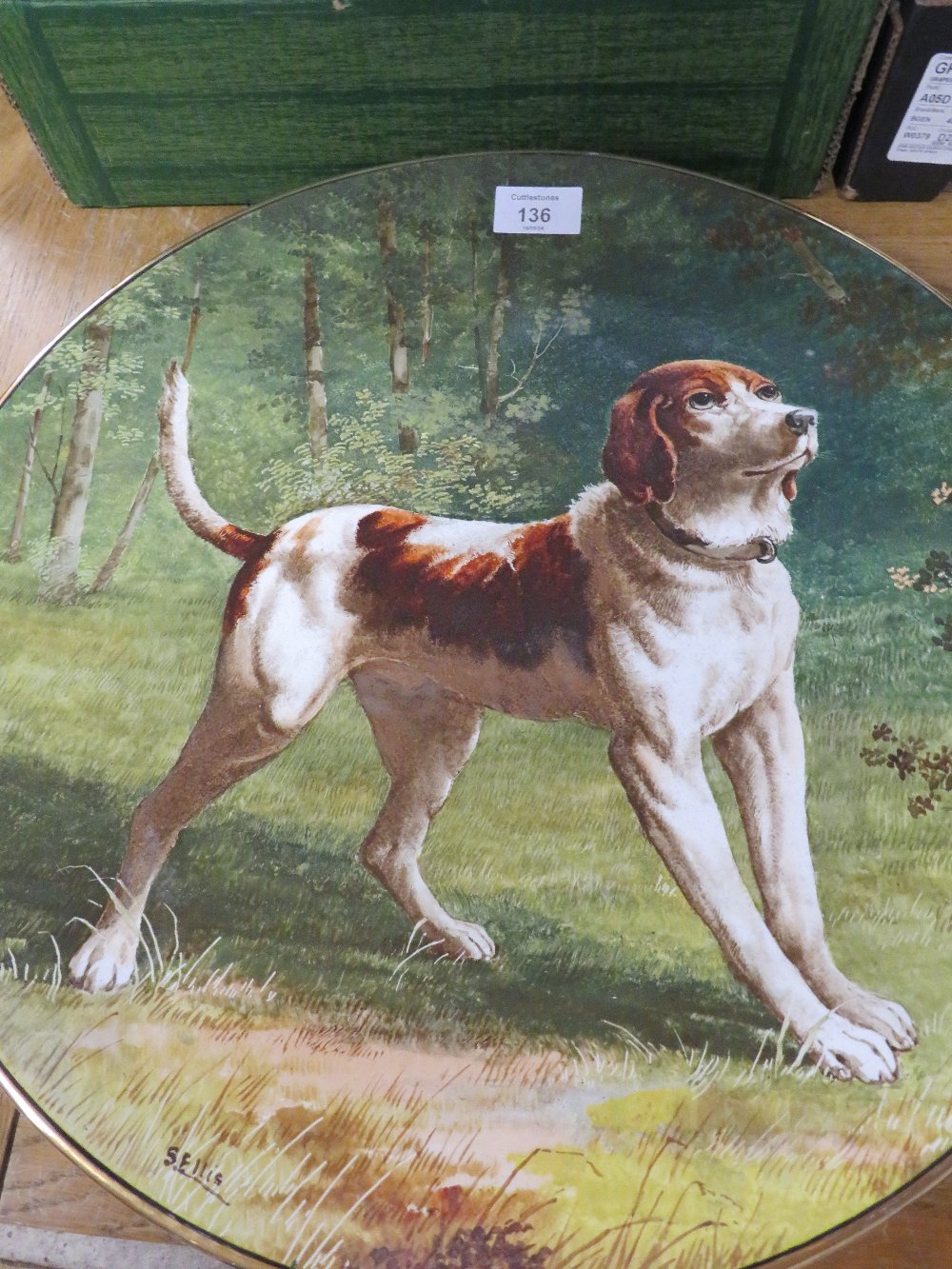 A LARGE CERAMIC CHARGER DECORATED WITH A DOG