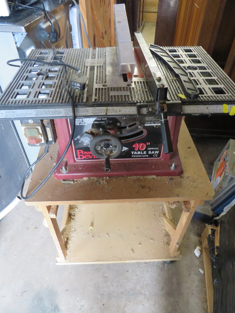 AN ELECTRIC TABLE TOP SAW AND BENCH - POWER DEVIL