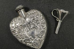 A HALLMARKED CONTINENTAL SILVER SMALL HEART SHAPE PERFUME BOTTLE TOGETHER WITH A FUNNEL