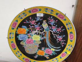 A LARGE ORIENTAL STYLE CHARGER DECORATED WITH A TROPICAL BIRD BY A BASKET OF FLOWERS