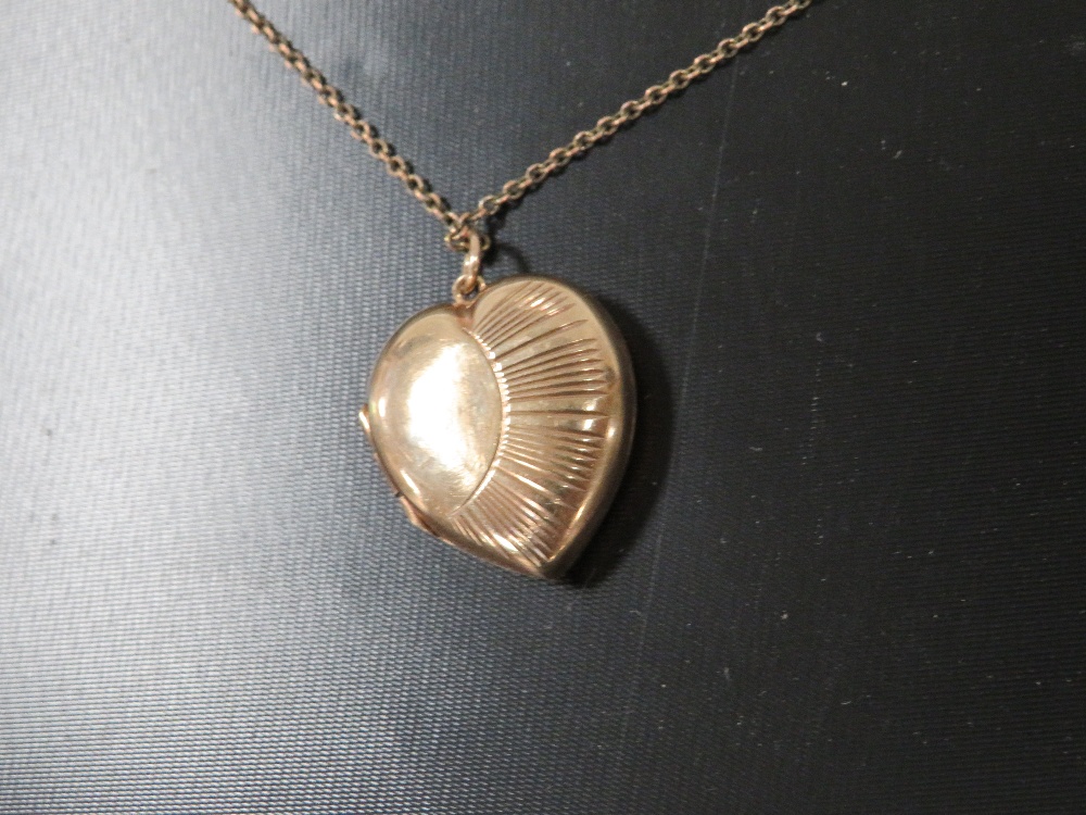 A LOCKET ON CHAIN MARKED 9CT GOLD BACK AND FRONT