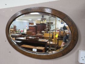 A LARGE MODERN GILT MIRROR AND AN OAK OVAL MIRROR (2)